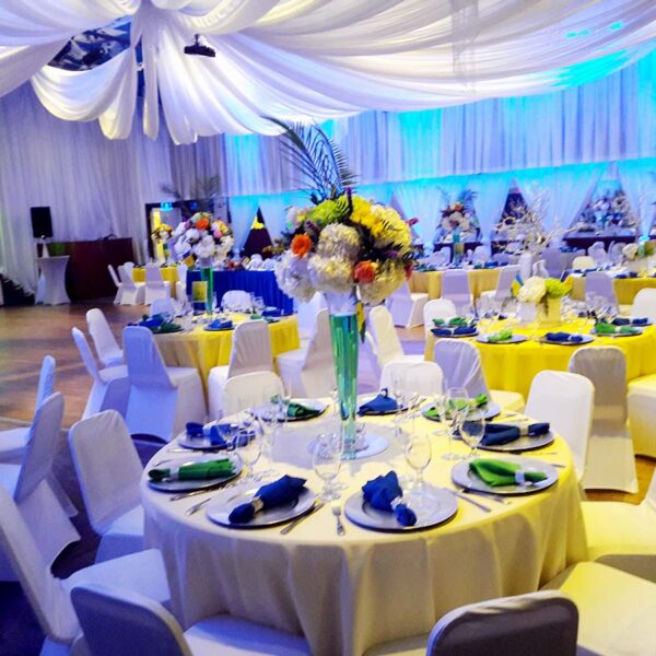 A banquet hall with tables and chairs set up for an event.