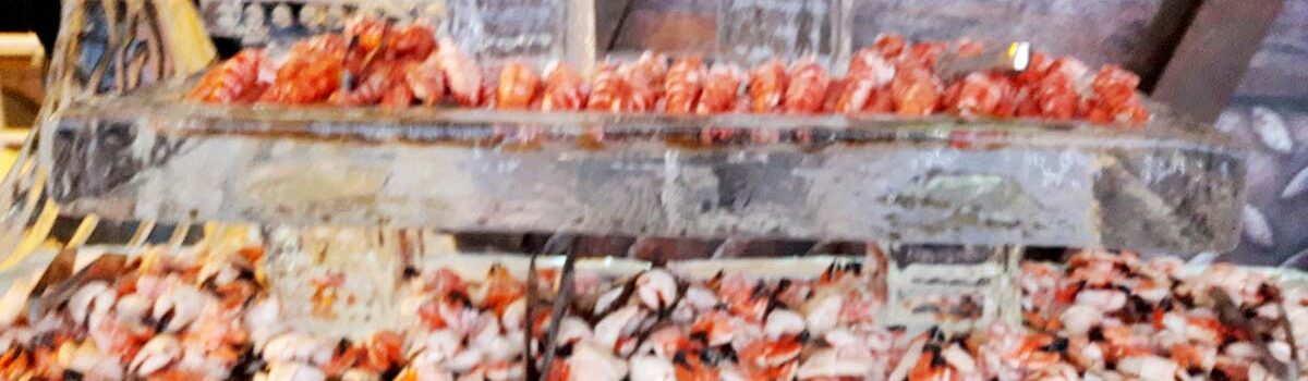 A large variety of seafood is being prepared.