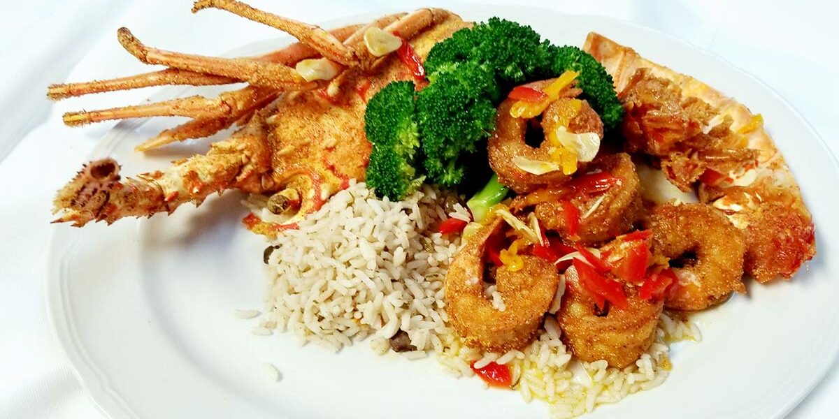A plate of food with rice and broccoli.
