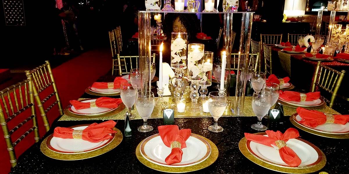A table set with plates and candles on it