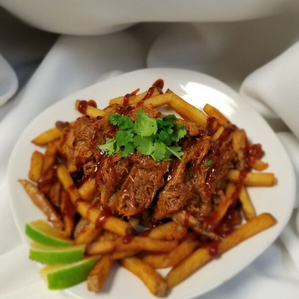 A plate of food with meat and fries on it.