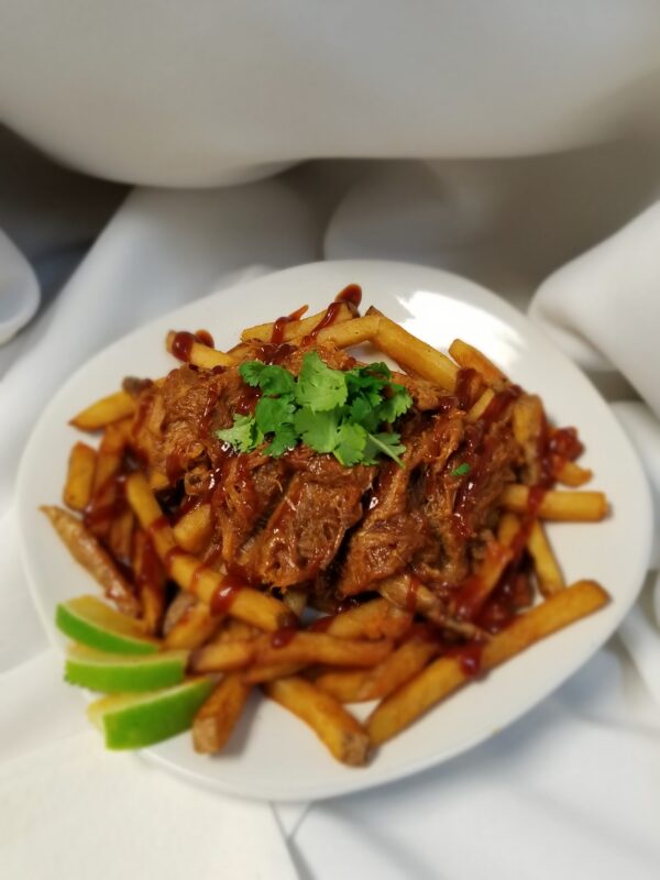 A plate of food with meat and fries on it.