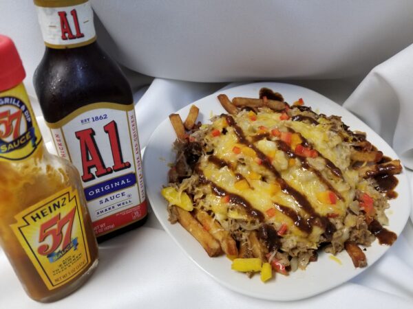 A plate of food and a bottle of beer.